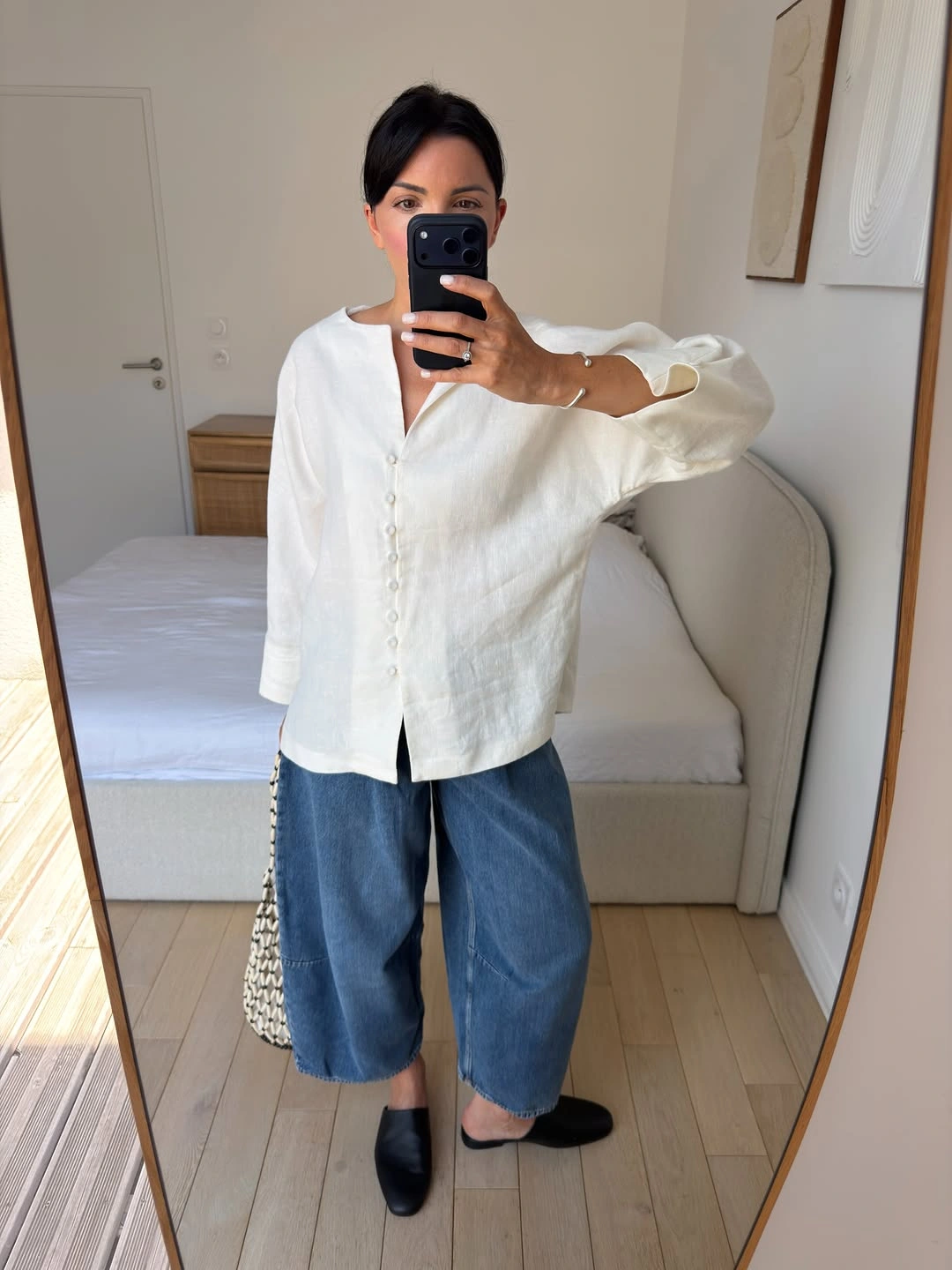 White button-front blouse with cropped wide blue jeans and black flats