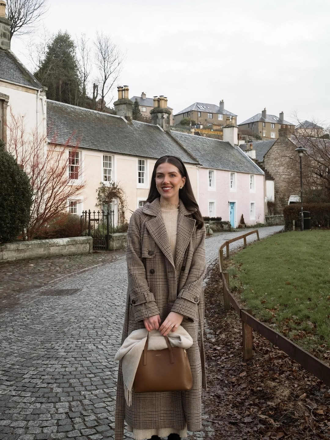 Long checked coat with cream knit and structured brown handbag