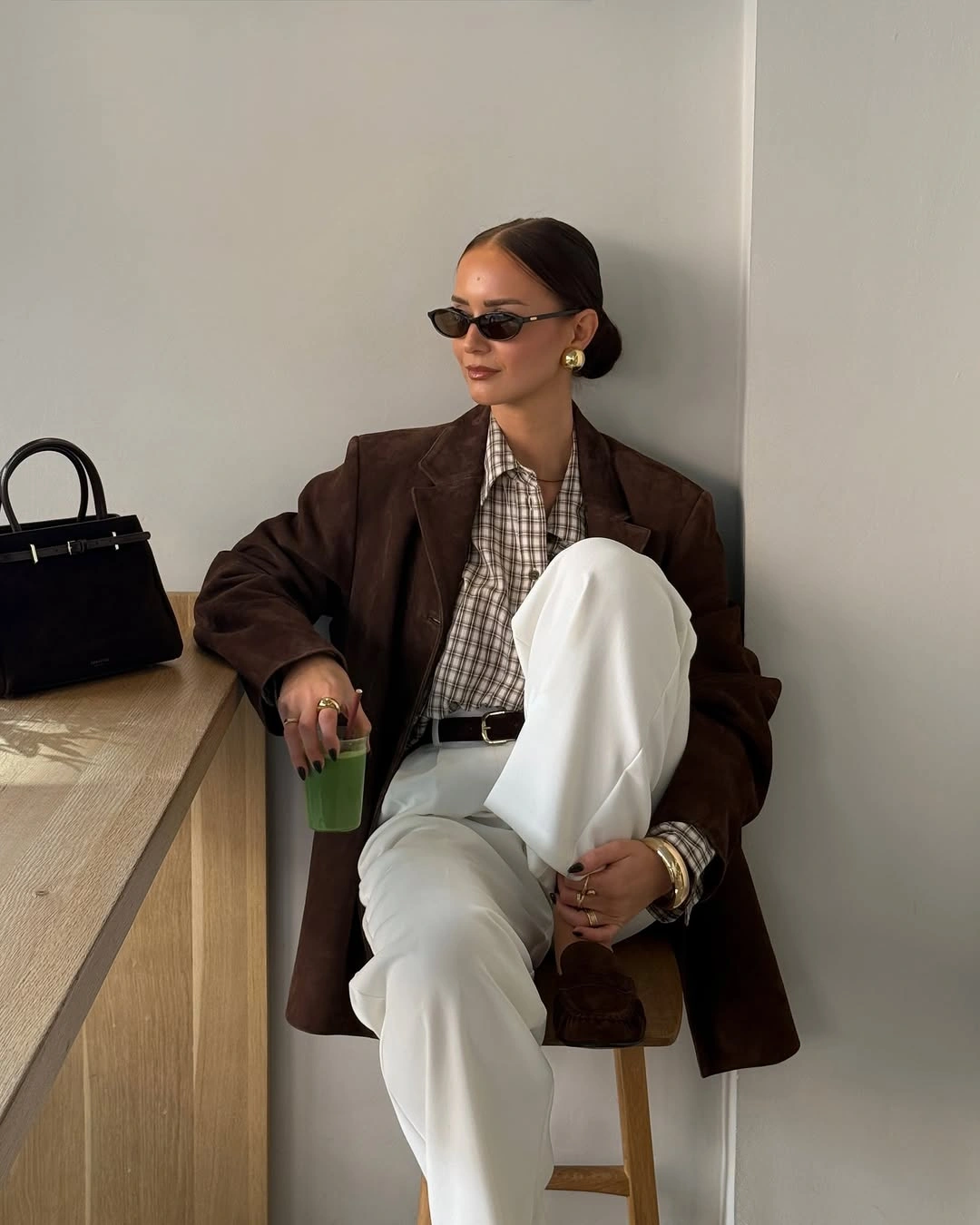 Chocolate oversized blazer, checked shirt, white wide-leg trousers, and black handbag