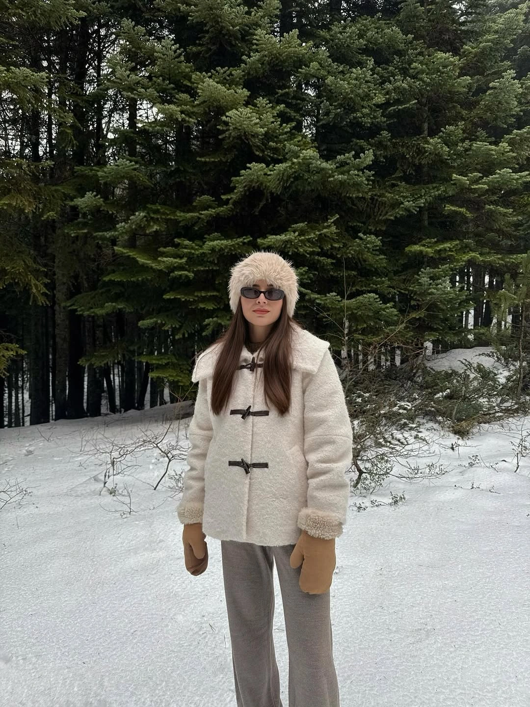 Cream textured toggle jacket with pale furry hat and brown mittens