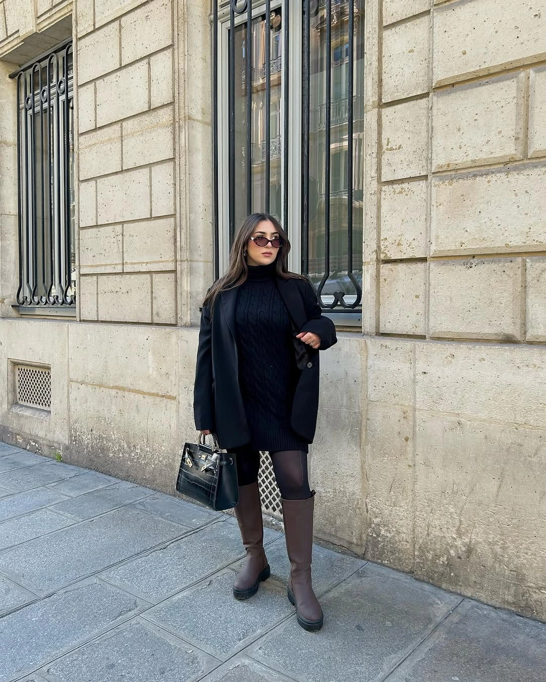Black blazer over short dark layer with patterned tights and brown boots