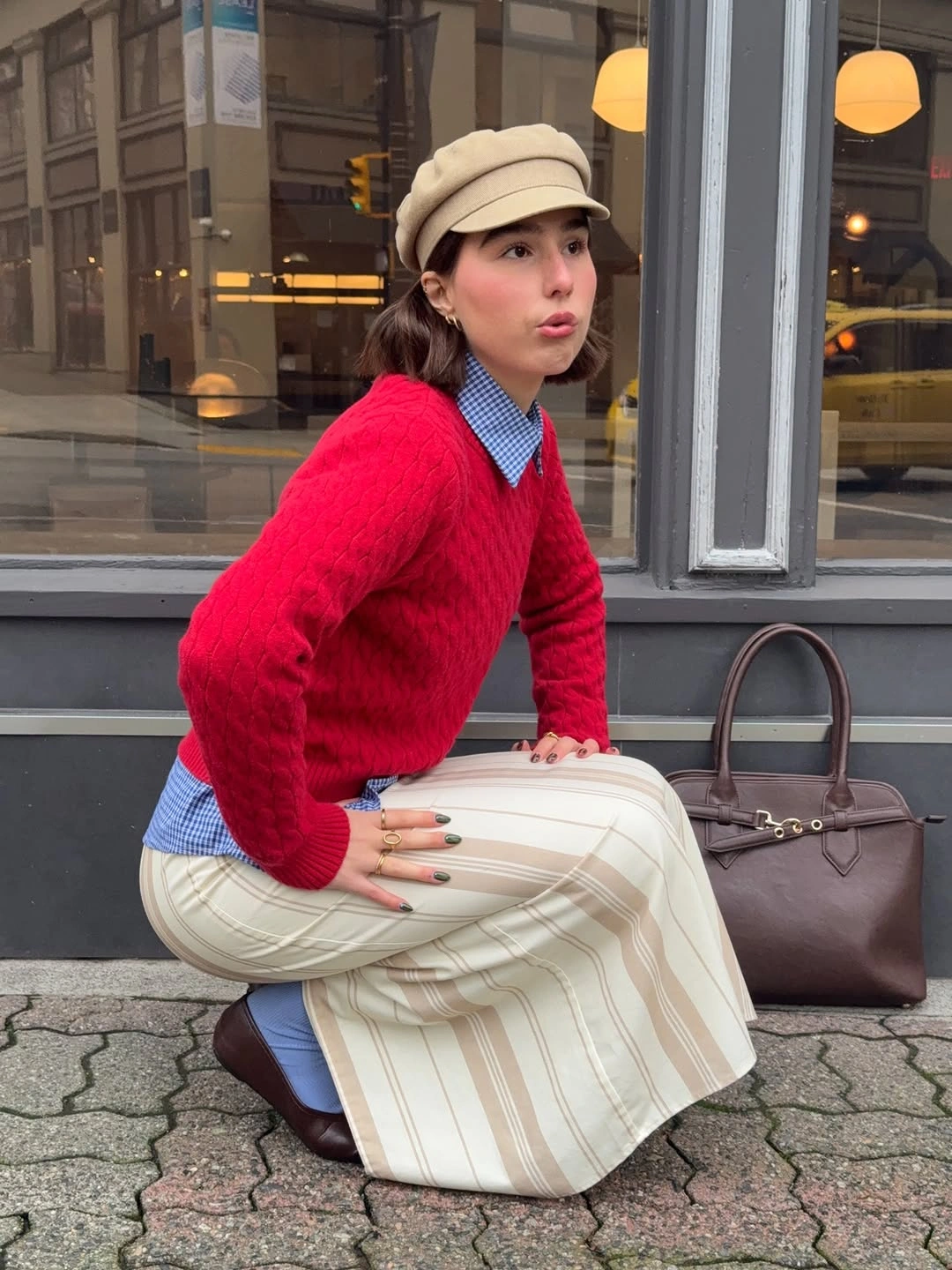Bright red cable knit over blue checked collar and cream striped lower garment