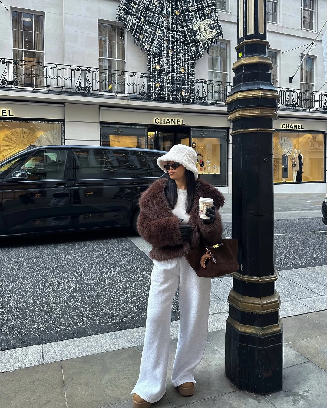 Cropped brown plush jacket with wide white pants and textured bucket hat