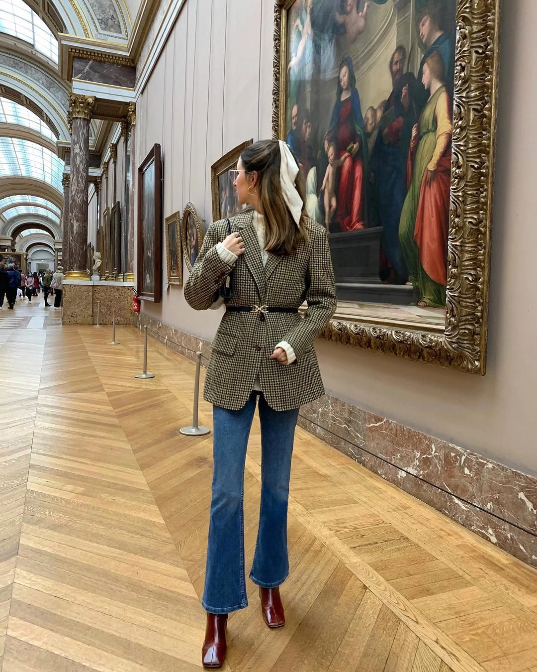 Checked belted blazer, flared blue jeans, burgundy boots, and light hair ribbon