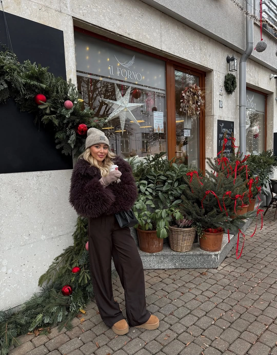 Dark plum fluffy jacket, brown wide-leg pants, gray beanie, and tan shoes