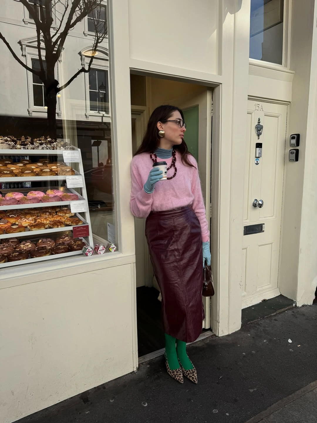 Pink sweater, burgundy midi skirt, green tights, teal gloves, and patterned heels