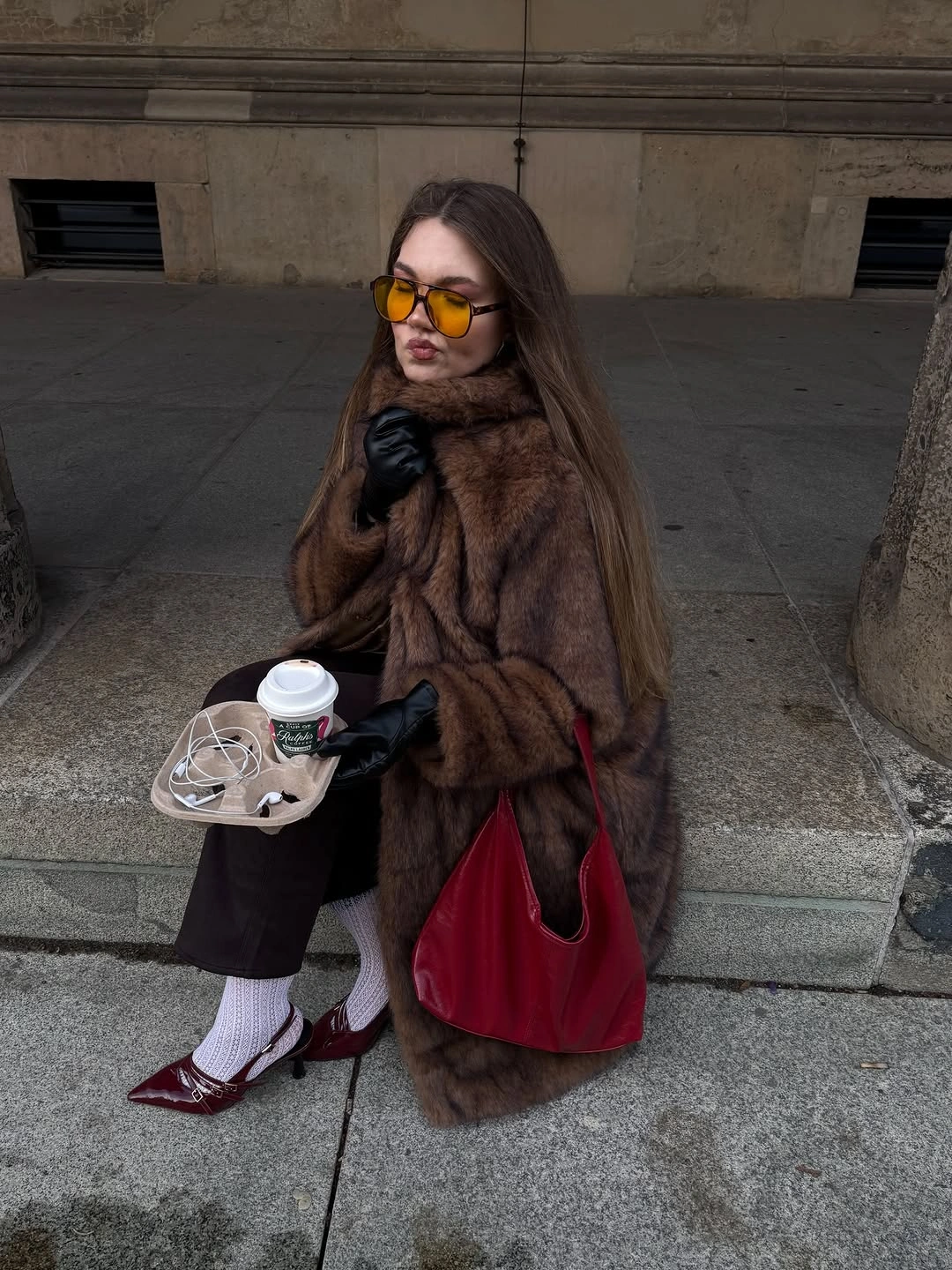 Brown plush jacket, burgundy handbag, burgundy shoes, and white socks