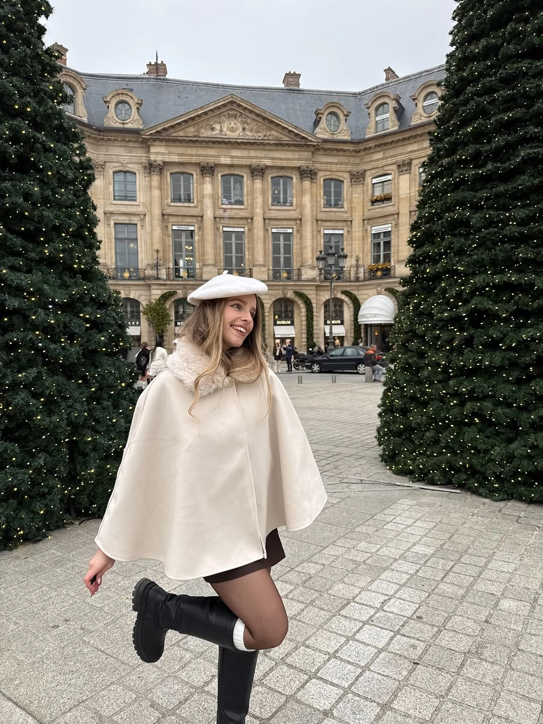 Cream cape with white beret, sheer tights and black boots
