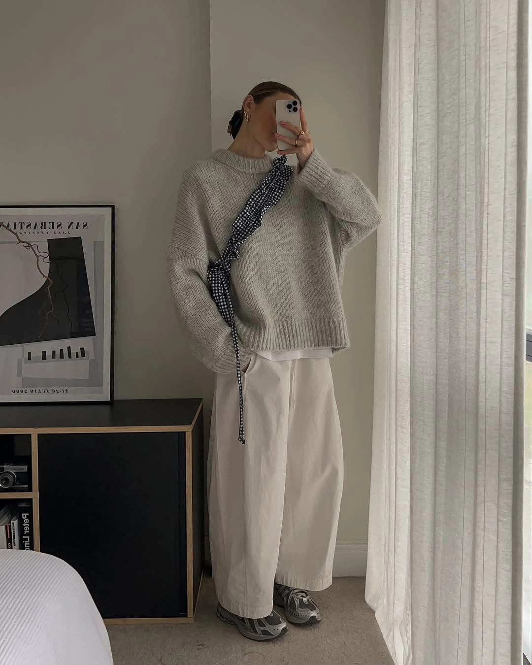 Gray oversized sweater with wide light trousers and patterned detail