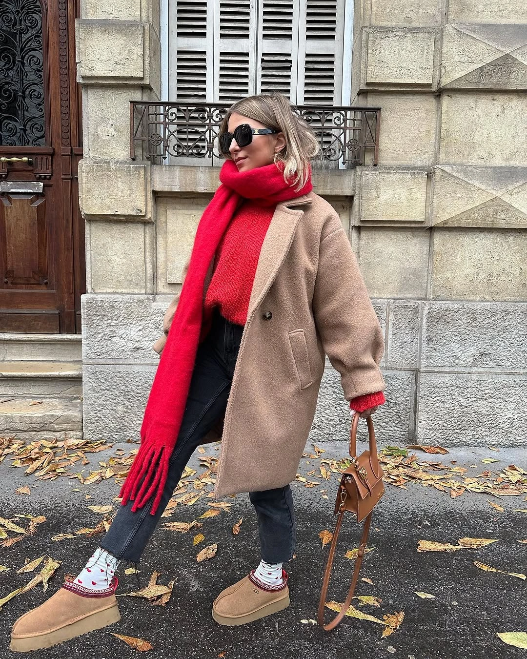 Camel coat with red scarf, cropped jeans and tan footwear